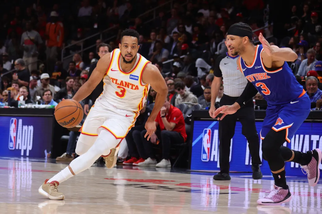 CJ McCollum drives against Knicks swingman Josh Hart during the 2026 NBA Playoffs.