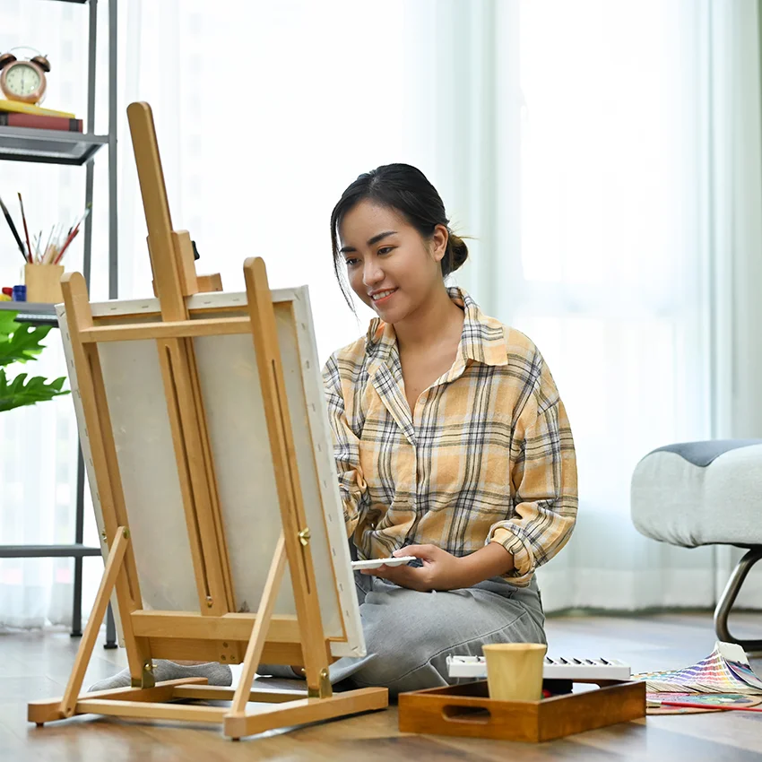 millennial woman enjoying free time by painting