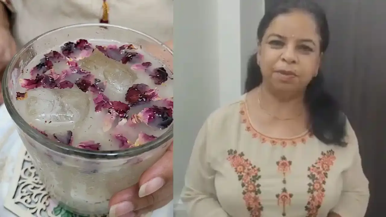 A refreshing glass of chilled Shikanjbean drink garnished with dried rose petals, held by a woman at home.