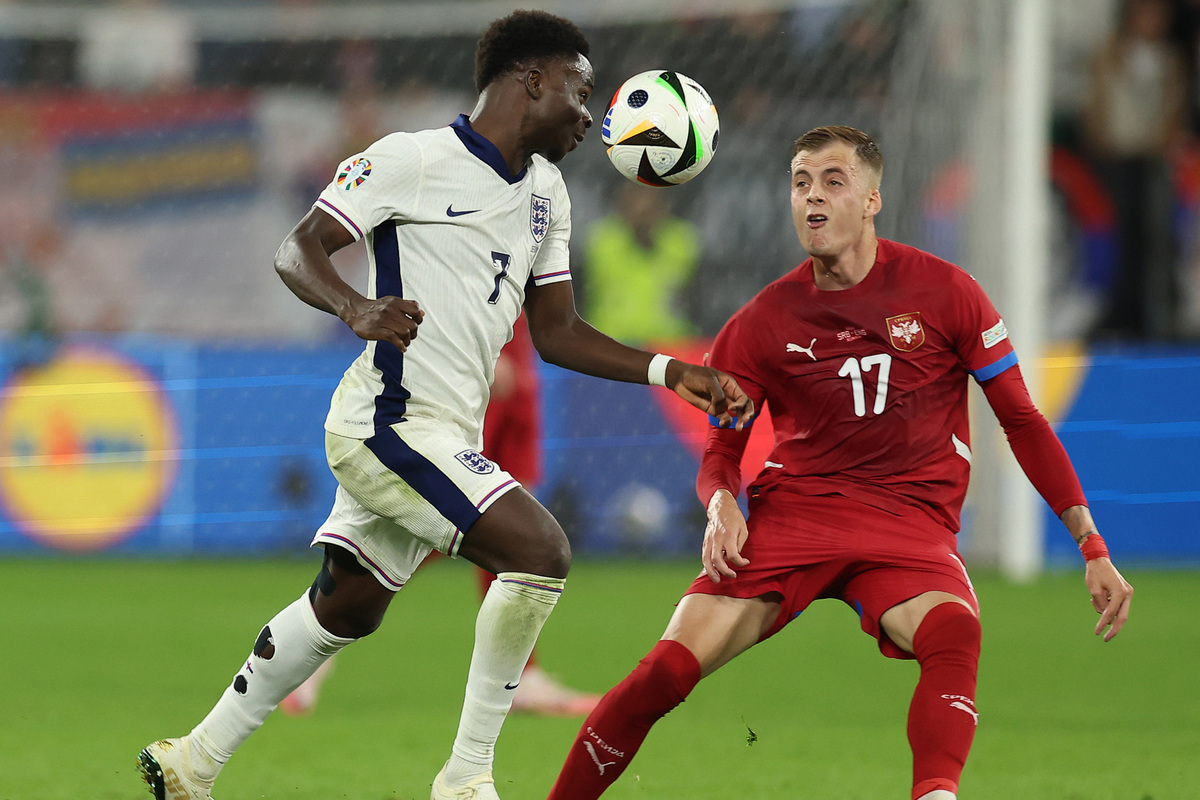 GELSENKIRCHEN, GERMANY - JUNE 16: Bukayo Saka of England and Ivan Ilic of Serbia during the UEFA EURO 2024 group stage match between Serbia and England at Arena AufSchalke on June 16, 2024 in Gelsenkirchen, Germany. (Photo by Richard Pelham/Getty Images)