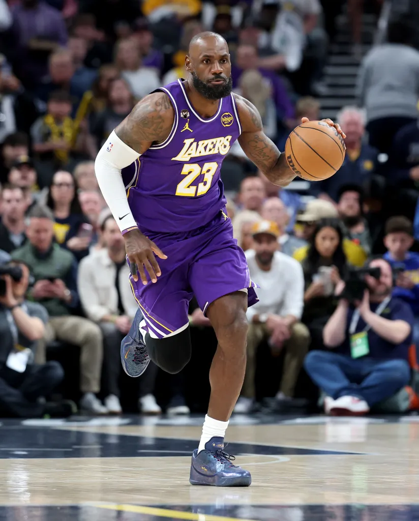 LeBron James dribbling a basketball in a Los Angeles Lakers jersey.