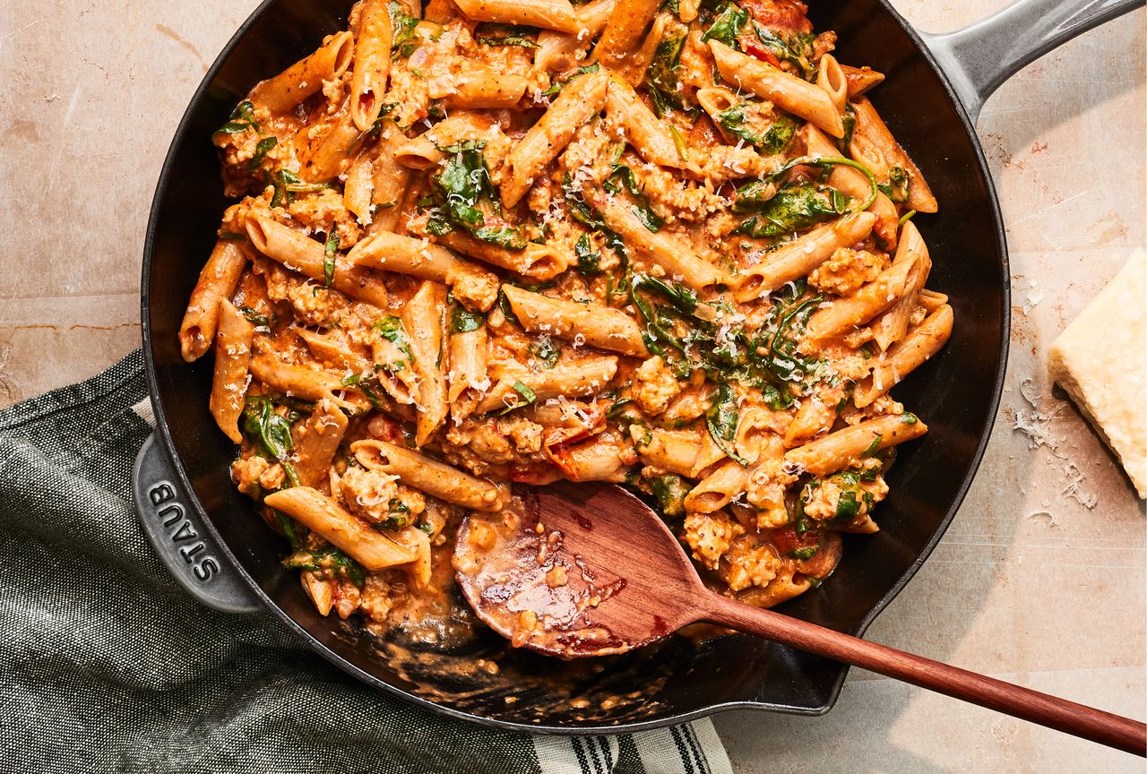 Overhead view of a cast iron skillet of One-Skillet Cheesy Ground Chicken Pasta recipe Credit: Photographer: Victor Protasio, Food Stylist: Ruth Blackburn, Prop Stylist: Christina Daley