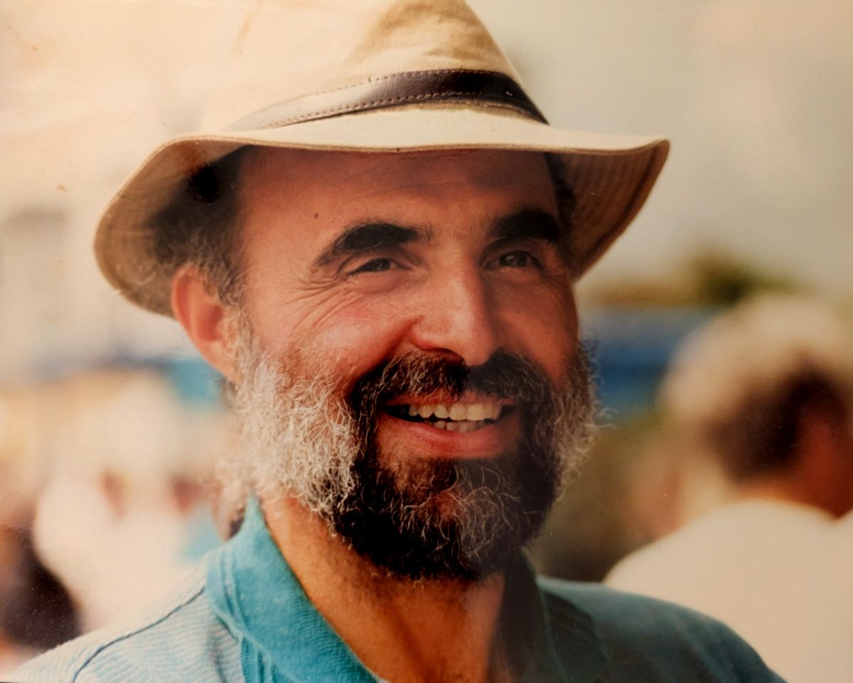 A man smiling and wearing a hat background blurred Credit: Courtesy of Subject