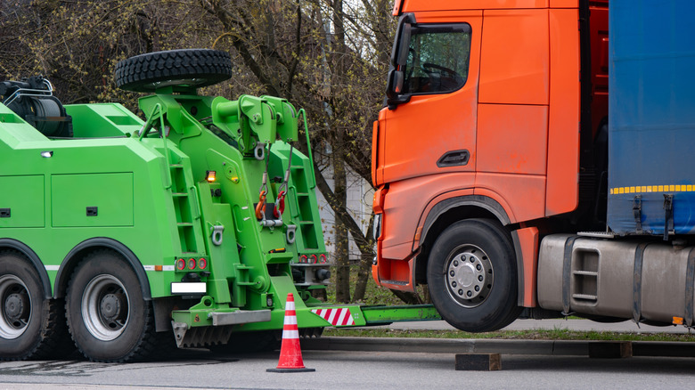 Heavy recovery truck towing a large lorry