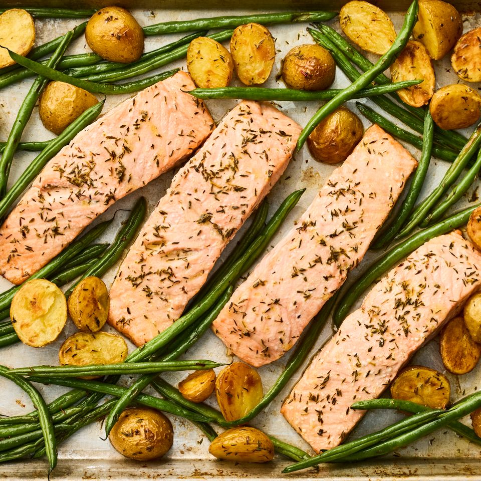 A recipe image of Sheet-Pan Roasted Salmon with Potatoes & Green Beans Credit: Photographer: Greg Dupree, Prop Stylist: Claire Spollen, Food Stylist: Chelsea Zimmer.