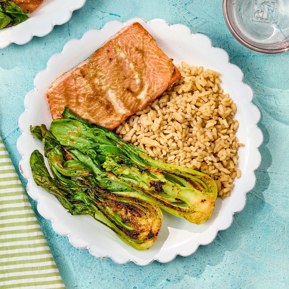a recipe photo of Sheet-Pan Salmon with Bok Choy & Rice Credit: Photographer: Robby Lozano, Food Stylist: Jennifer Wendorf, Prop Styling: Josh Hoggle.
