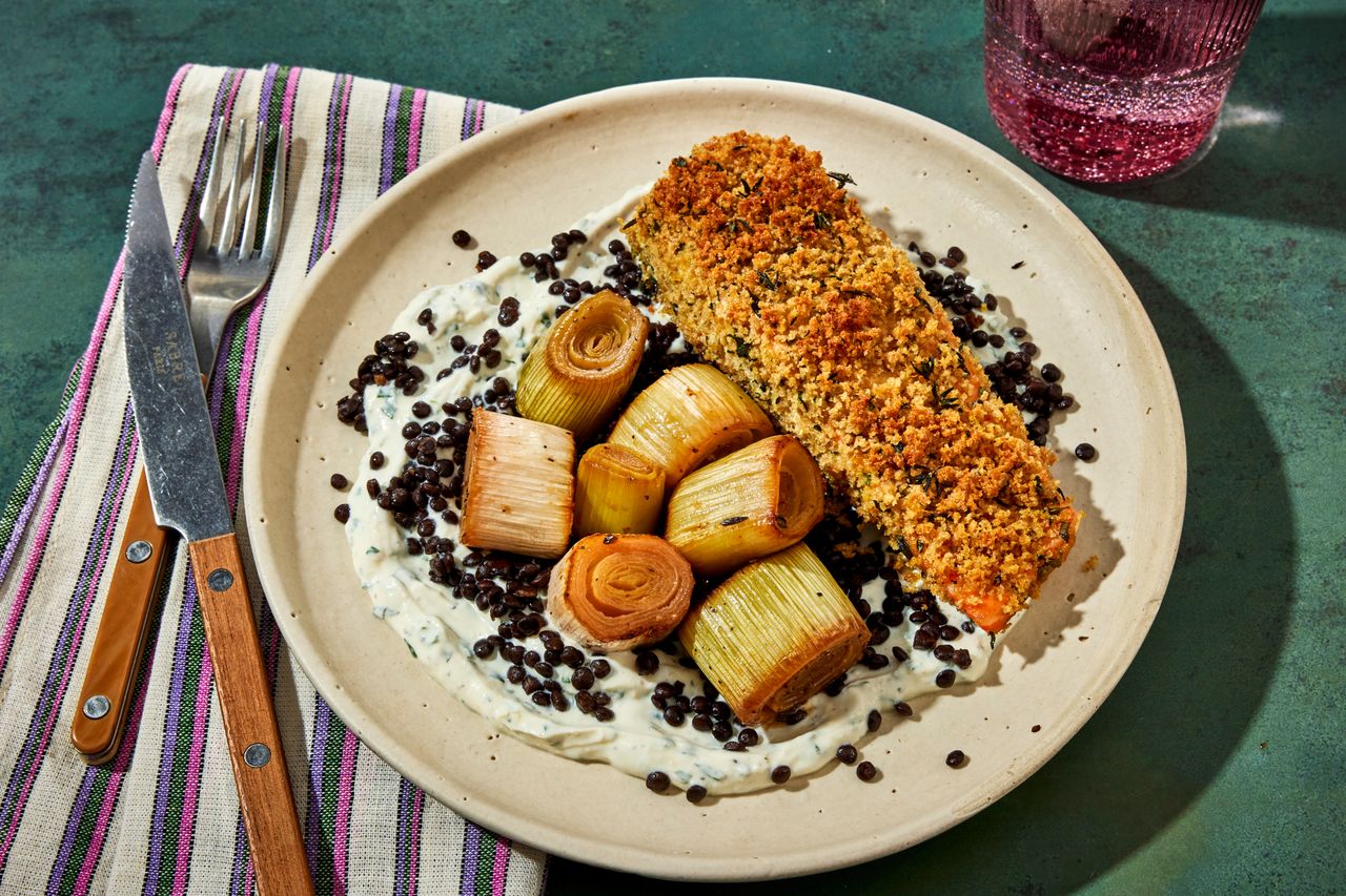 a photo of the Sheet Pan Crusted Salmon with Sliced Leeks served on a ceramic plate Credit: Photographer: Jen Causey, Food Stylist: Jennifer Wendorf, Prop Stylist: Christina Brockman