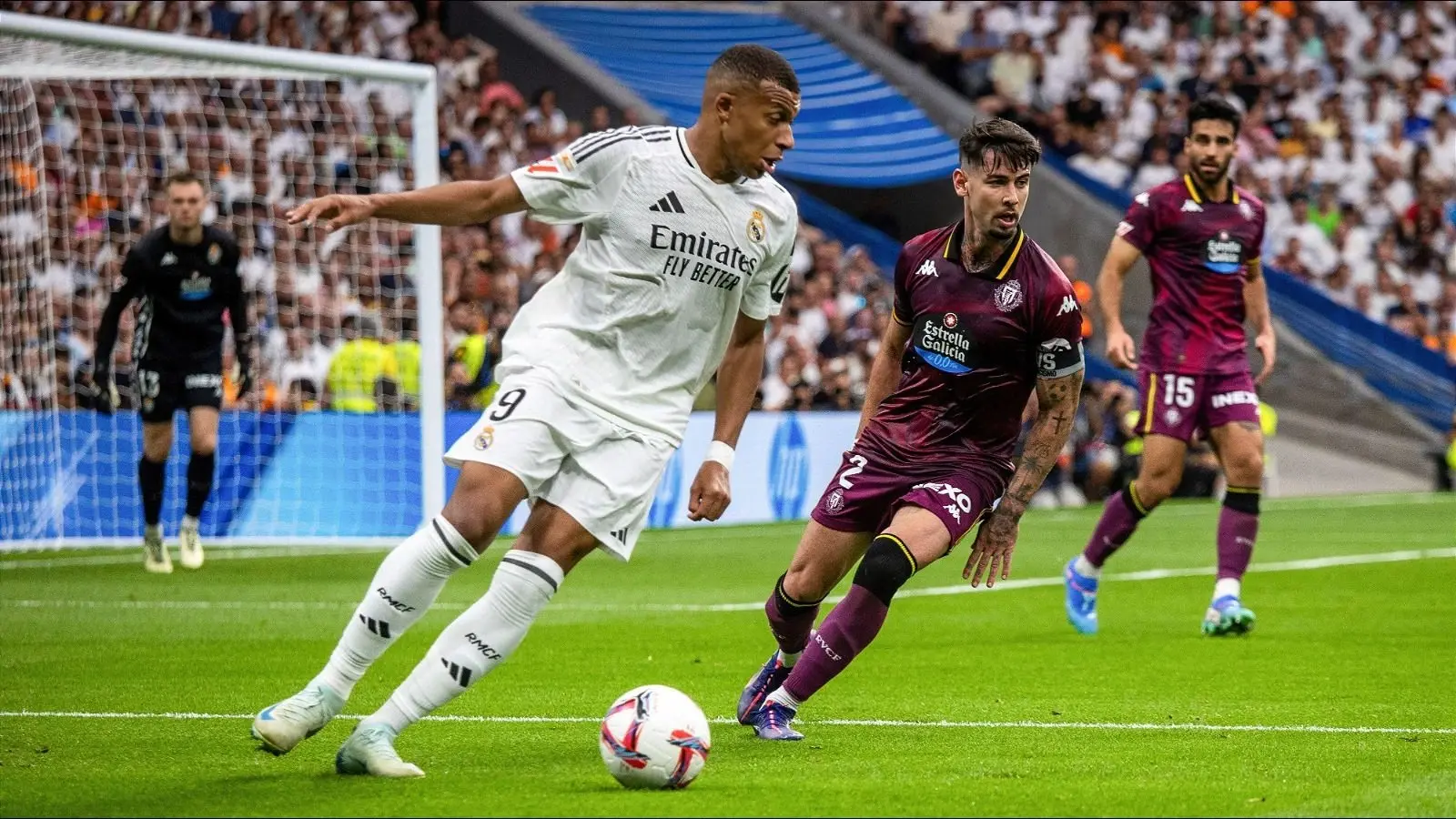 Kylian Mbappe dribbling a football while playing for Real Madrid.