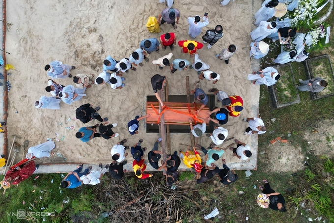 Many residents continue to follow the traditional practice of burial. Photo by Read/Vo Thanh.