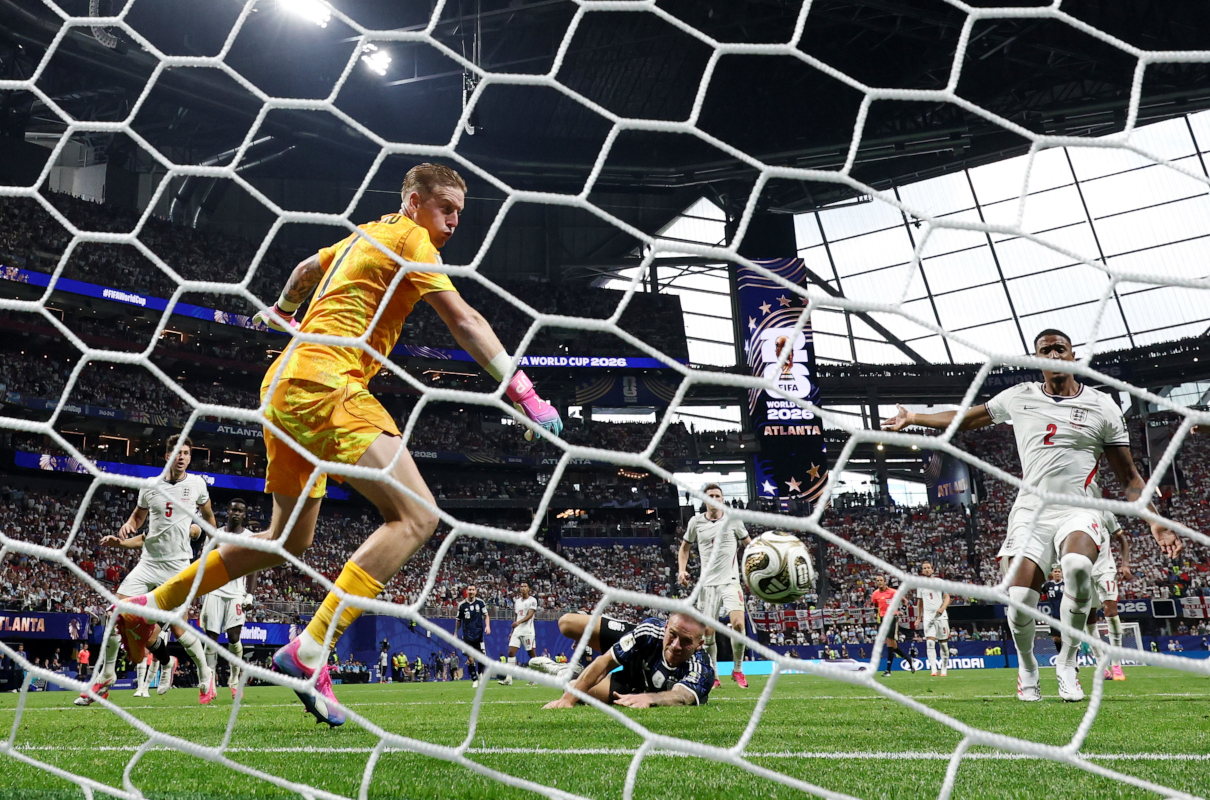 ATLANTA, GEORGIA - JULY 15: (EDITOR'S NOTE: Image was captured using a remote camera from behind the goal.) Alexis Mac Allister #20 of Argentina attempts a header against Jordan Pickford #1 of England during the FIFA World Cup 2026 Semi Final match between England and Argentina at Atlanta Stadium on July 15, 2026 in Atlanta, Georgia. (Photo by Buda Mendes/Getty Images)