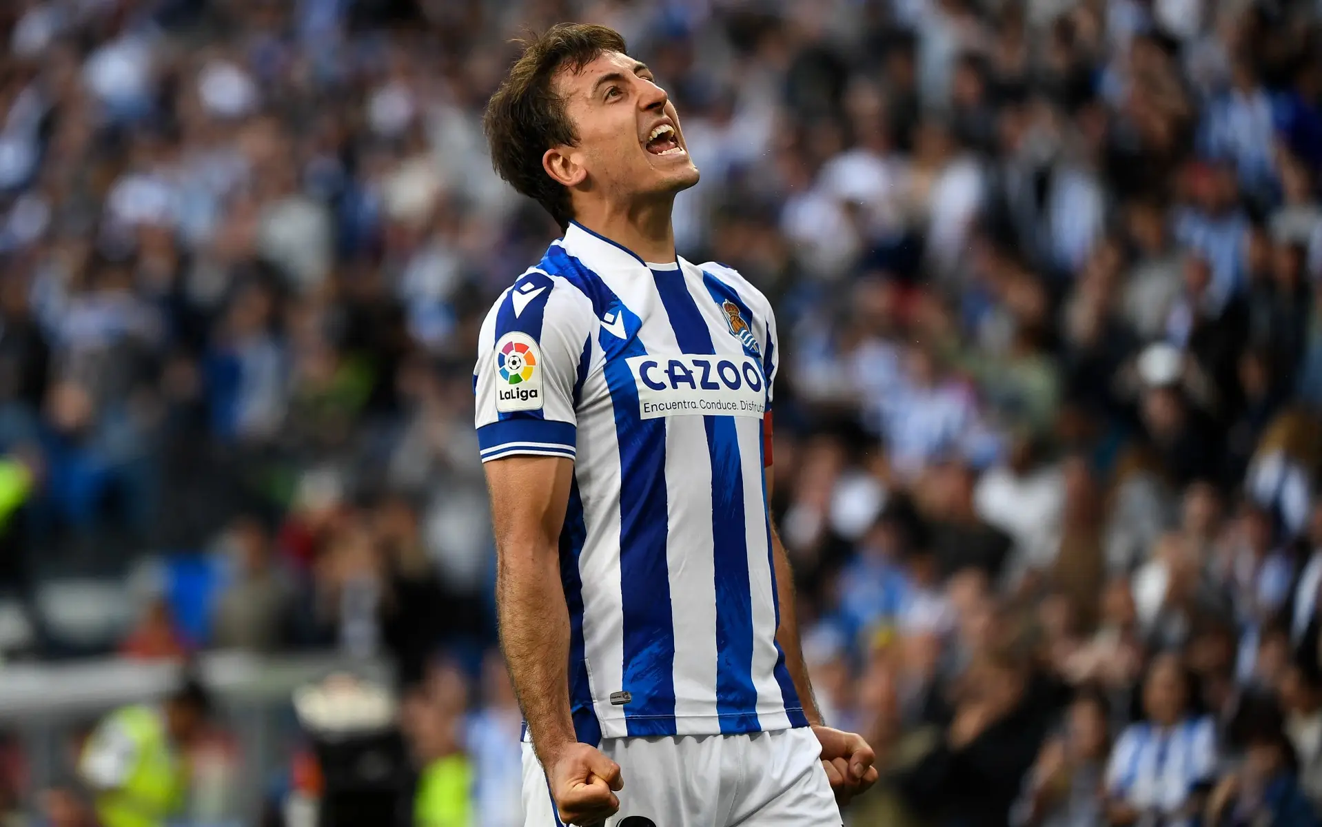 Mikel Oyarzabal celebrating a goal in Real Sociedad's blue and white kit.