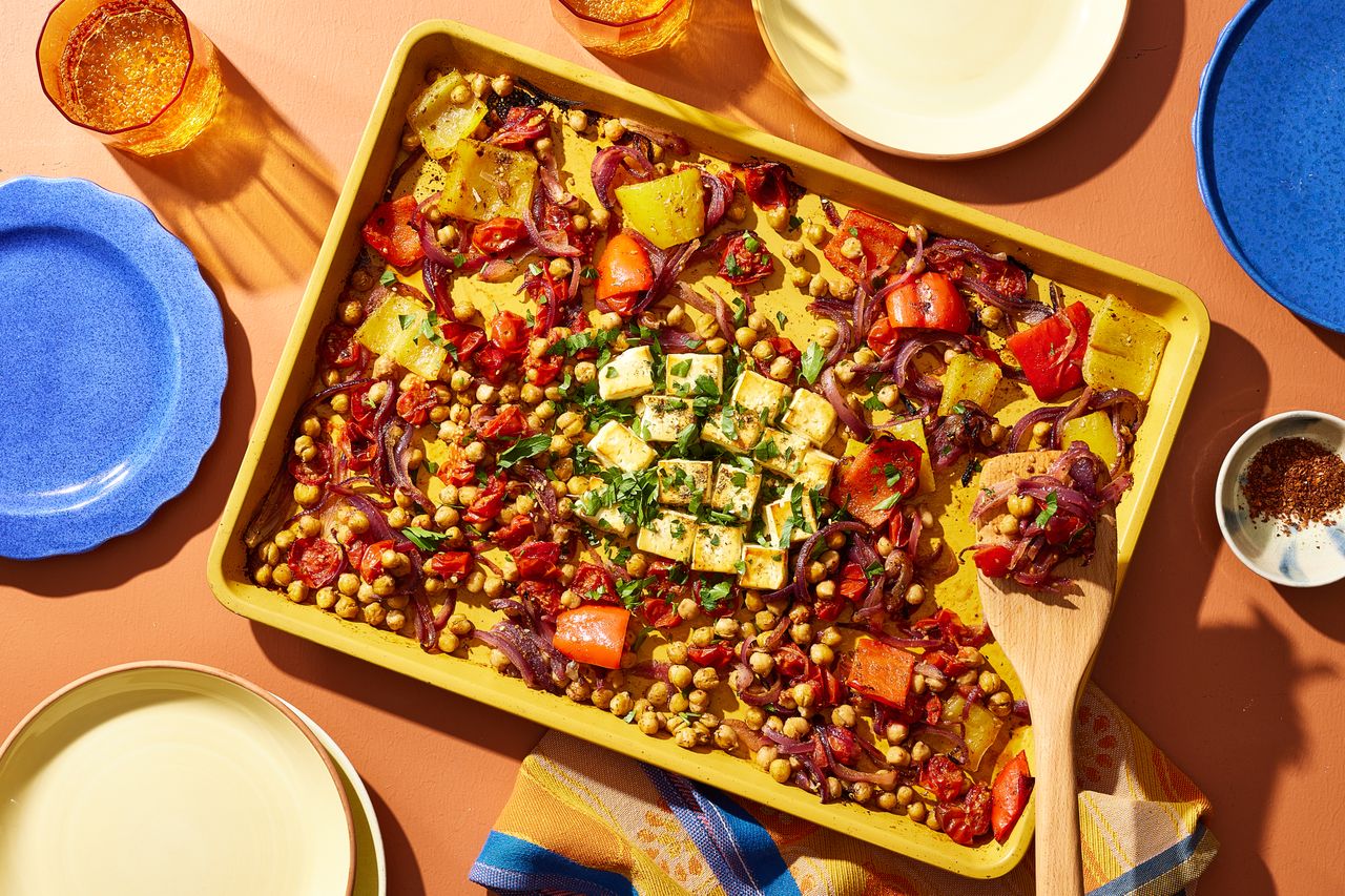 a recipe photo of the Sheet-Pan Baked Feta, Bell Peppers, Red Onion, Cherry Tomatoes & Chickpeas Credit: Photographer: Brie Goldman, Food Stylist: Addelyn Evans, Prop Stylist: Gabriel Greco
