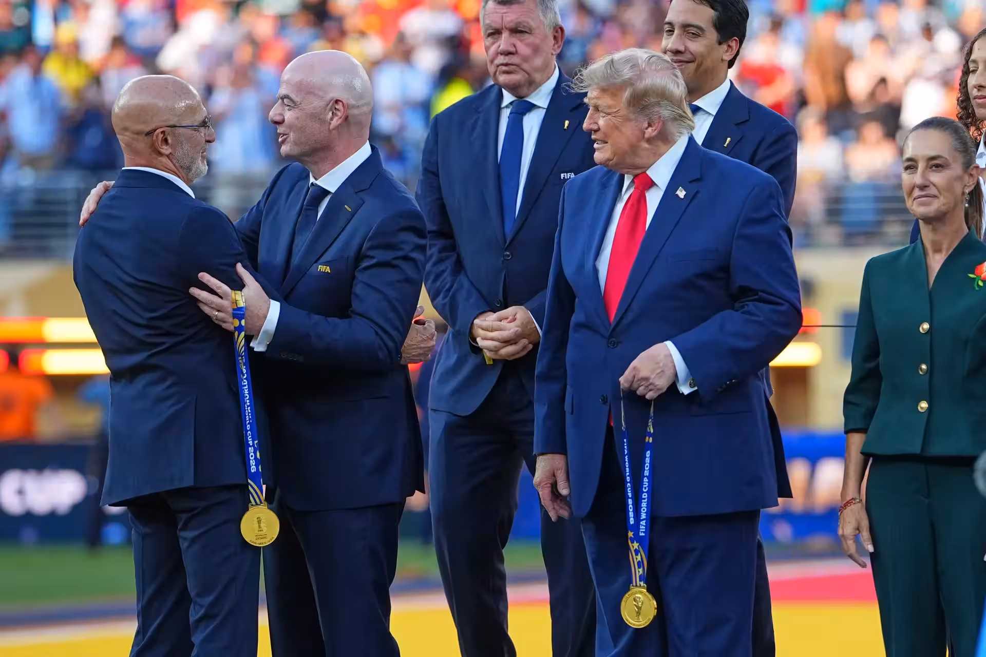 Spain head coach Luis de la Fuente, left, is greeted by FIFA President Gianni Infantino and President Donald J. Trump during the presentation ceremony after the World Cup final soccer match between Spain and Argentina in East Rutherford, N.J., near New York, Sunday, July 19, 2026. (AP Photo/Julio Cortez) Argentina Spain WCup Soccer