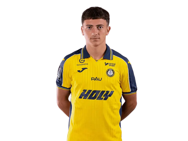 Giovani Versini in a yellow Pau FC jersey posing for a portrait.