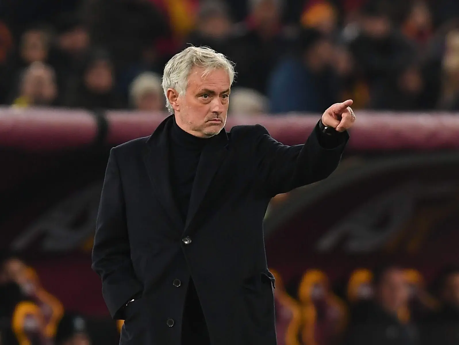 Jose Mourinho gesturing on the sidelines during a football match.