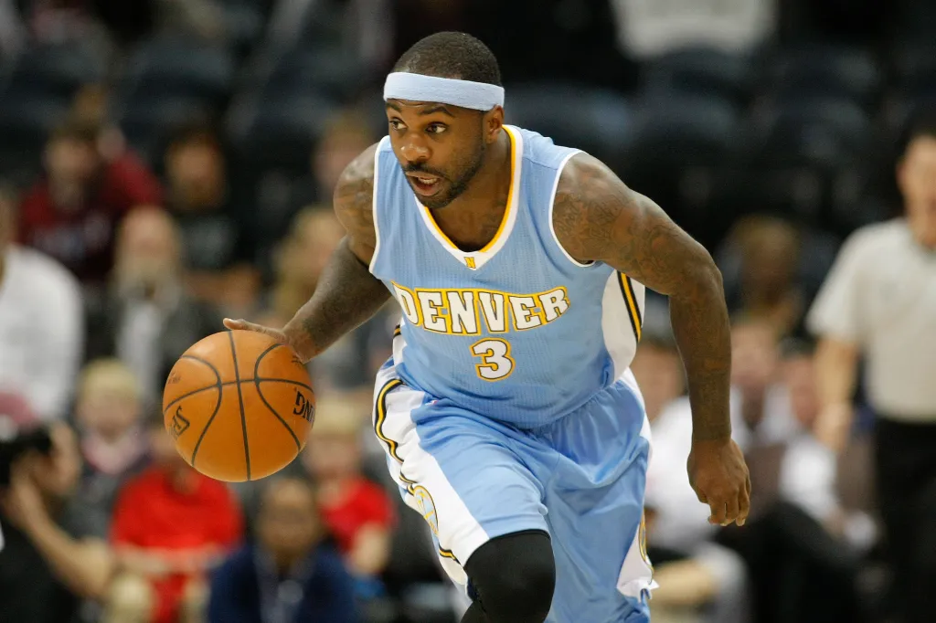 Denver Nuggets guard Ty Lawson dribbling the ball.