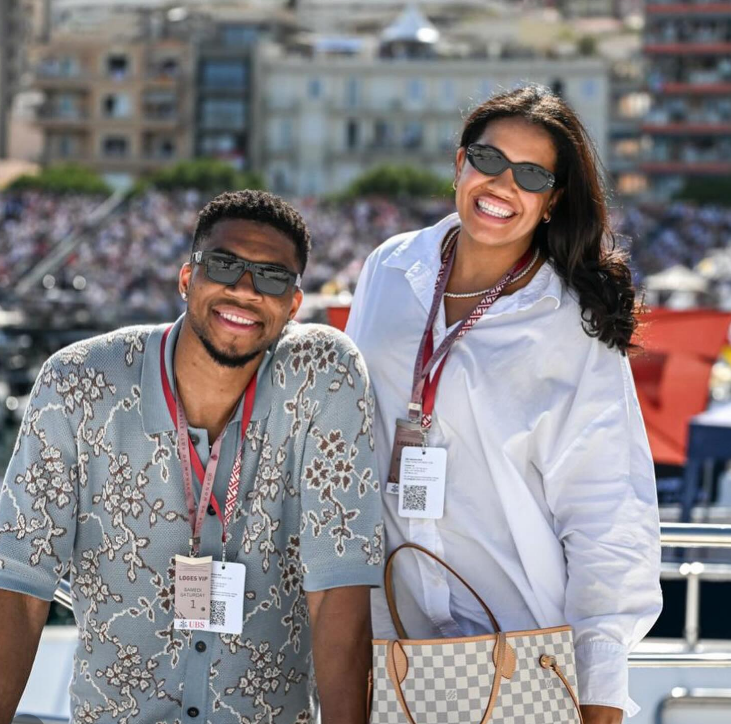 Giannis Antetokounmpo and Mariah Riddlesprigger smiling.
