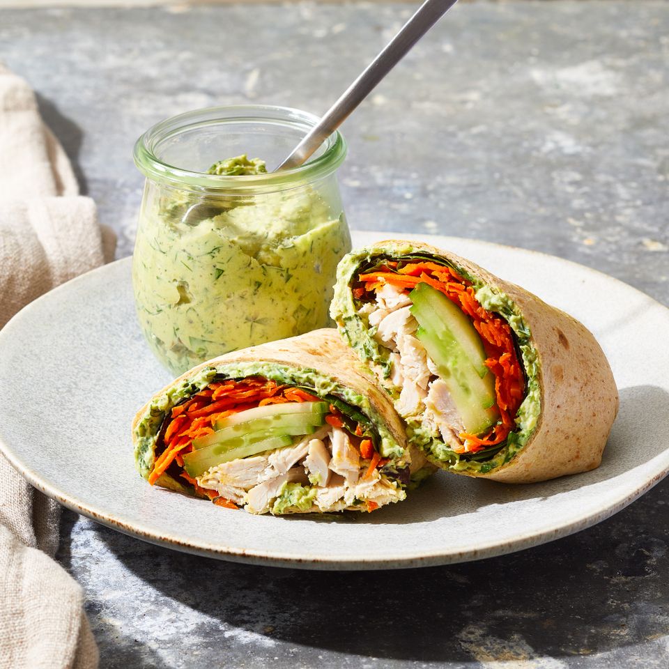 Cucumber Chicken Green-Goddess Wrap on a plate with a side of Green Goddess dressing in a small jar with a spoon Credit: Brie Passano