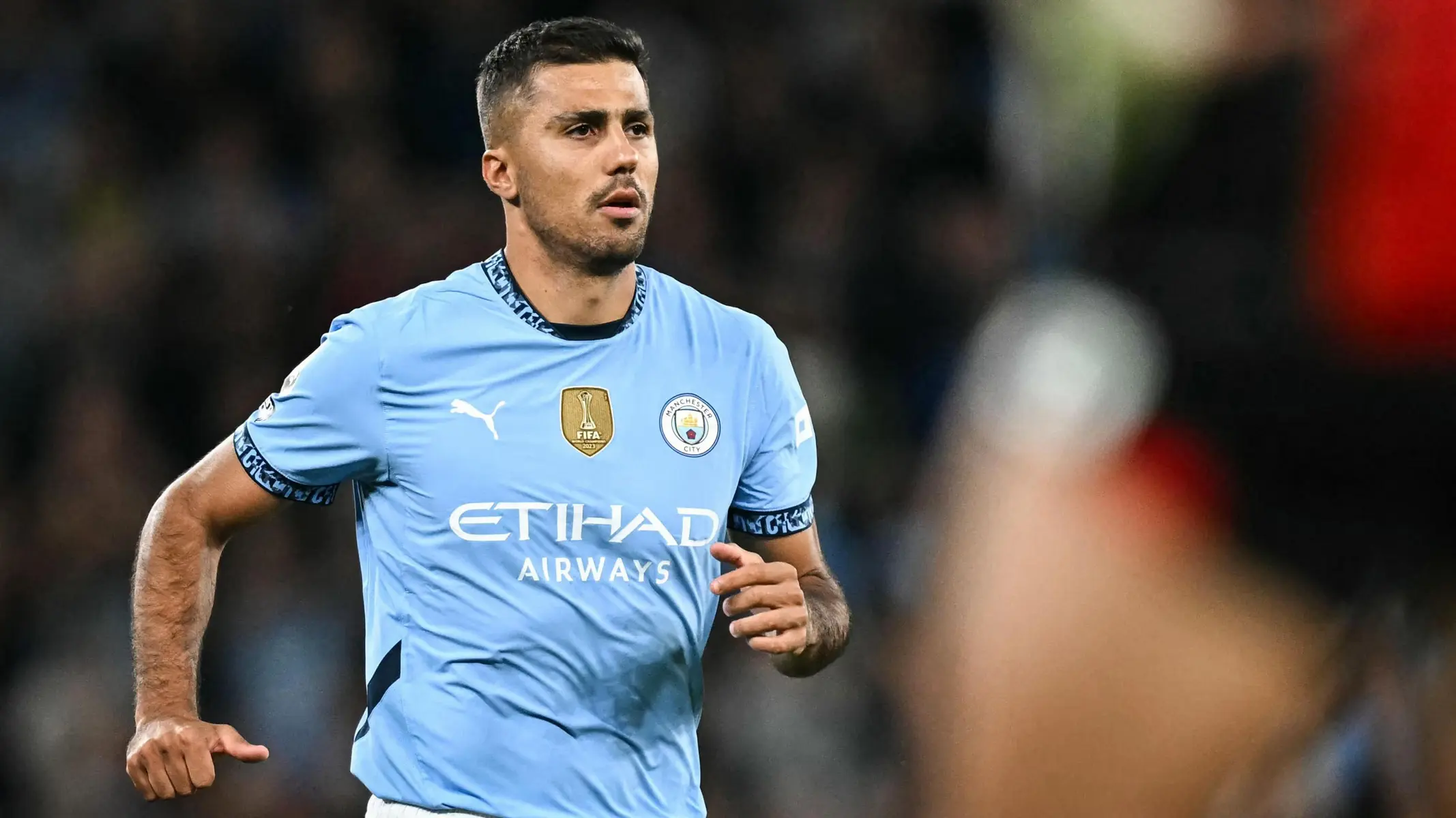 Manchester City midfielder Rodri wearing the light blue home kit during a match