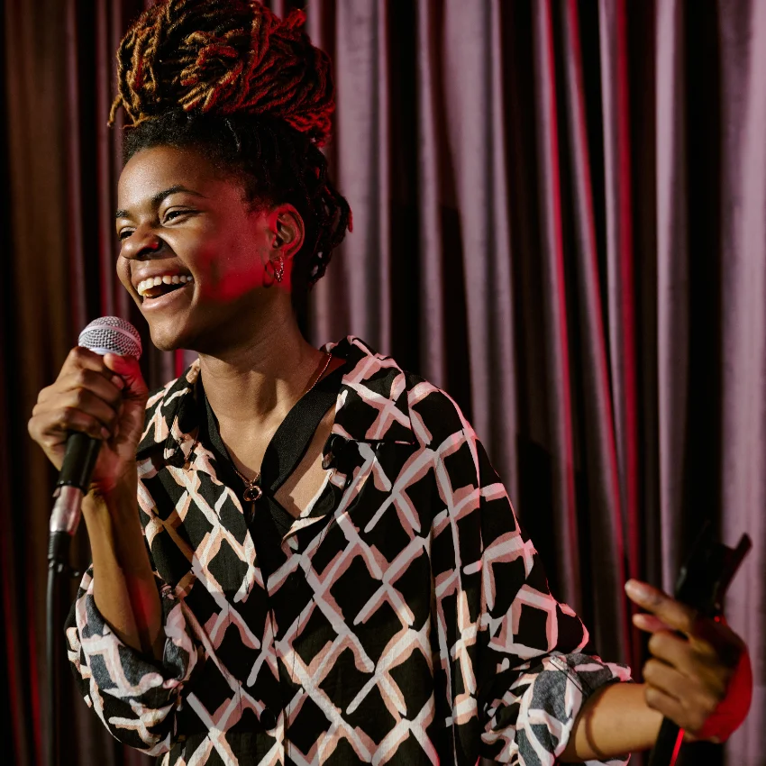 Woman doing comedy and theatre on a stage.
