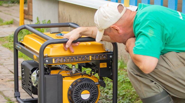 A man inspecting a generator