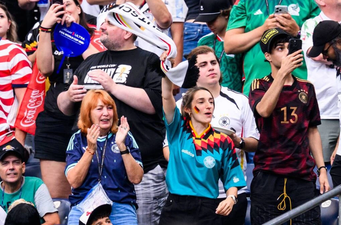 Burgi (clapping) and Lena Wurzenberger (waving scarf), mother and girlfriend of head coach Julian Nagelsmann, cheer on Germany in their opening match of the 2026 World Cup against Curacao, at the NRG Stadium in Houston, USA on June 14, 2026. Photo by AFP