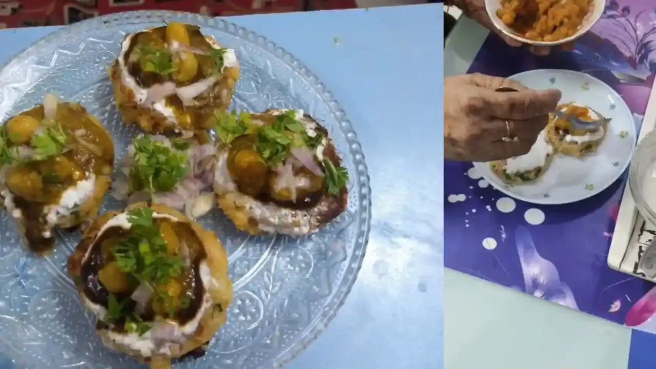 Crispy aloo tikki chaat served on a glass plate topped with creamy yogurt, tangy chutneys, and fresh coriander.