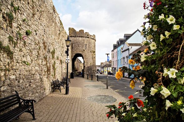 Tenby town wall along South Parade with seasonal flower decoration Tenby town wall along South Parade with seasonal flower decoration