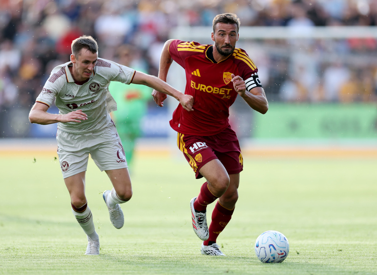 NEWPORT, WALES - AUGUST 04: Bryan Cristante of AS Roma is challenged by Ciaran Brennan of Newport County during the pre-season friendly match between Newport County and AS Roma at Rodney Parade on August 04, 2026 in Newport, Wales. (Photo by Dan Istitene/Getty Images)