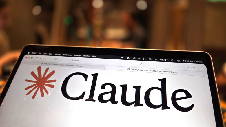 The Claude logo is seen on a laptop