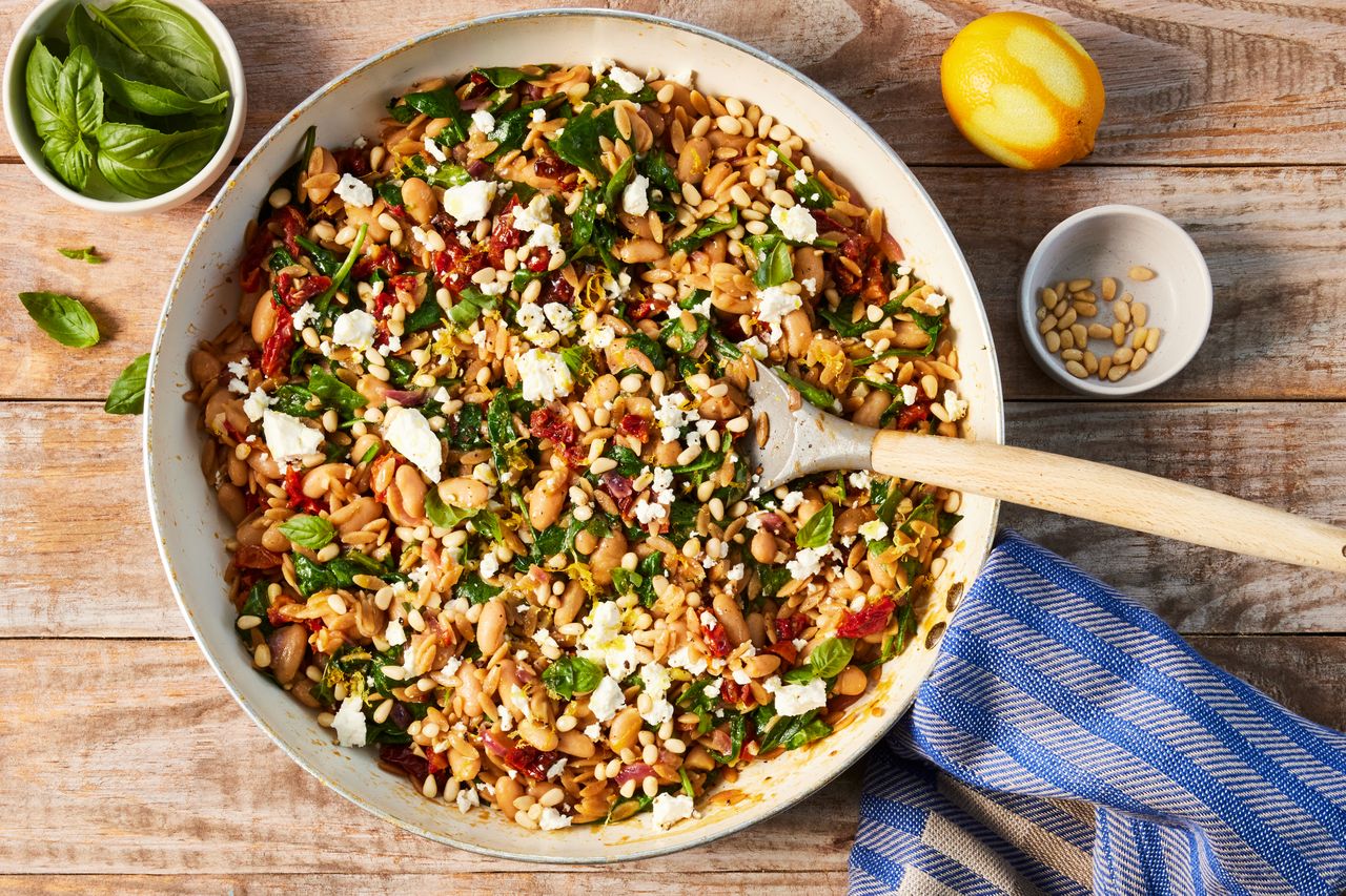 a recipe photo of the One-Pot White Bean, Spinach & Sun-Dried Tomato Orzo with Lemon & Feta Credit: Photographer: Jen Causey, Food Stylist: Julian Hensarling, Prop Stylist: Julia Bayless