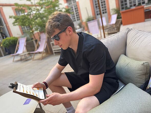 Nathan looking at a menu Nathan looking at a menu