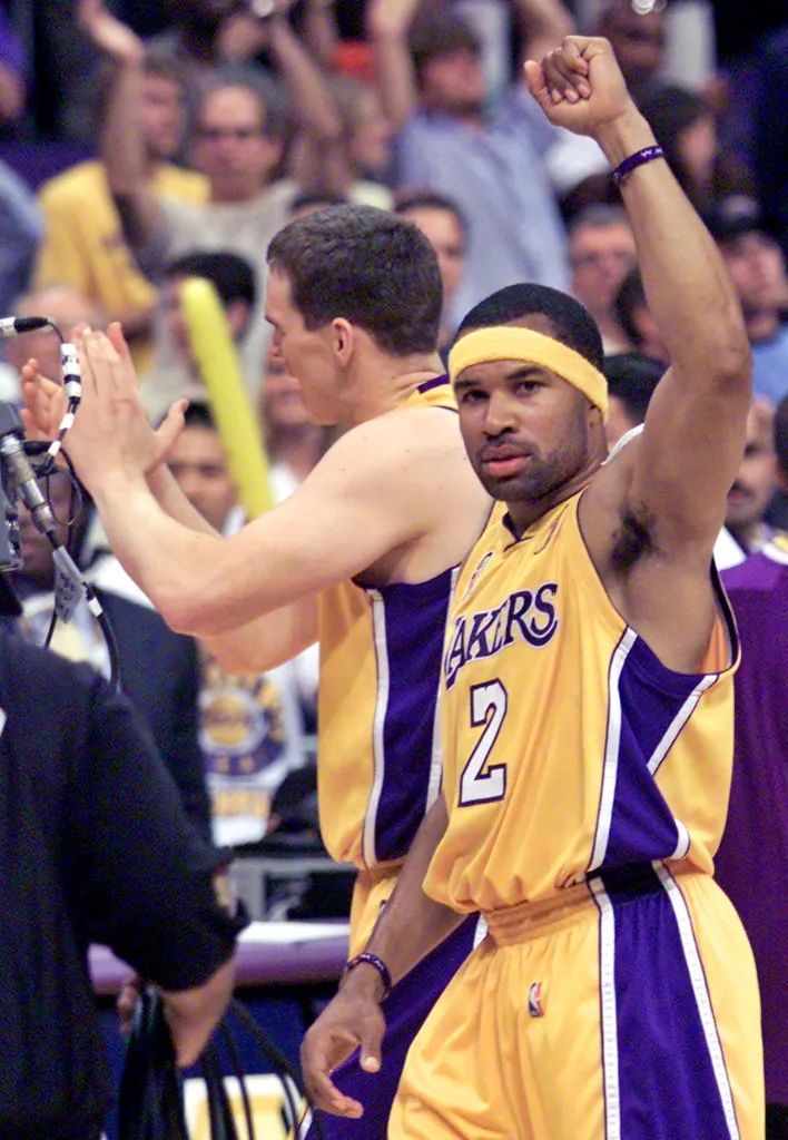 Two Lakers players Derek Fisher celebrate during the NBA finals.