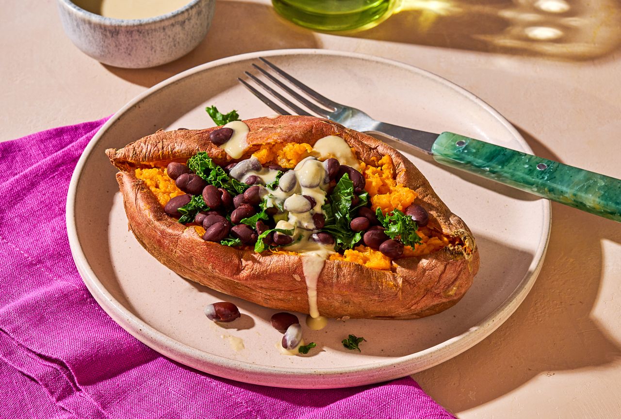 Stuffed Sweet Potato with Hummus Dressing, low angle on a plate Credit: Ali Redmond