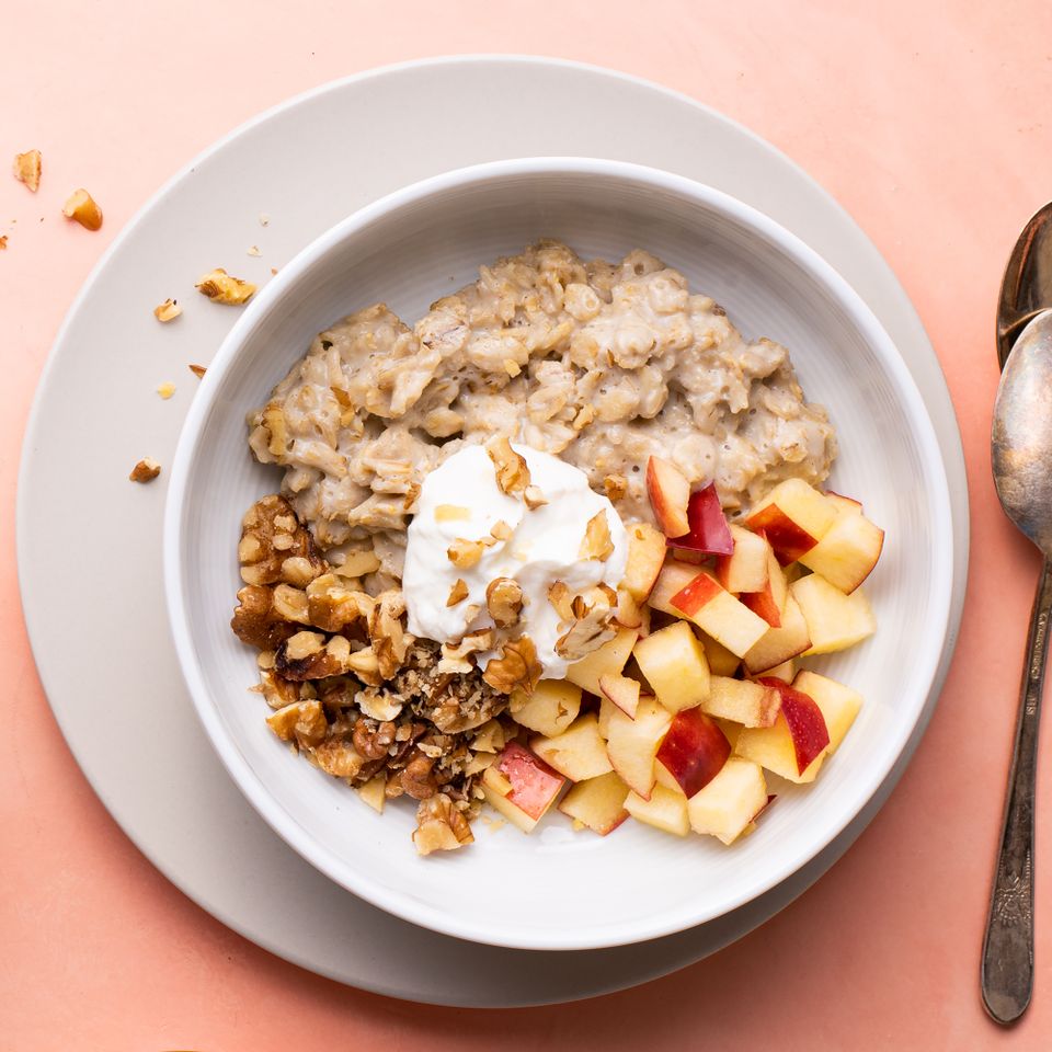 Overhead view of a white bowl of Oatmeal with Fruit & Nuts recipe Credit: Photographer: Alexander Shytsman