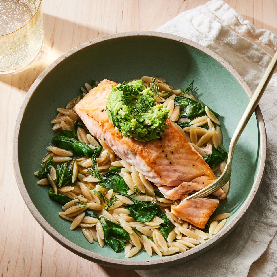 a recipe photo of the Skillet Salmon with Orzo & Green Pea Pesto Credit: Photographer: Rachel Marek, Food stylist: Holly Dreesman, Prop stylist: Gabriel Greco