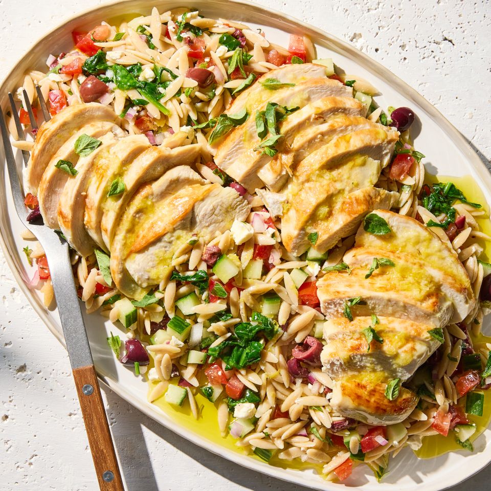 A recipe image of Chicken with Spinach & Tomato Orzo Salad. Credit: Photographer: Grant Webster, Food Stylist: Holly Dreesman, Prop Stylist: Dera Burreson.