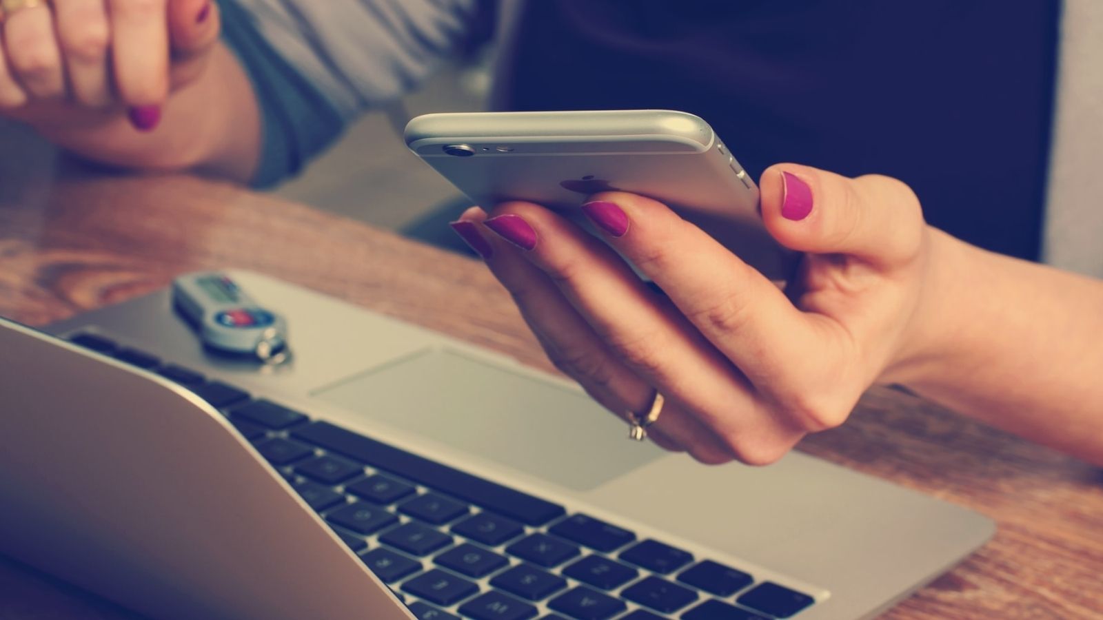 digital payments A Person Using iPhone With Laptop