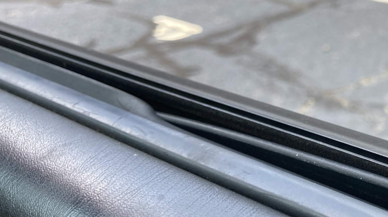Close-up of sticking weather stripping in right-side car door
