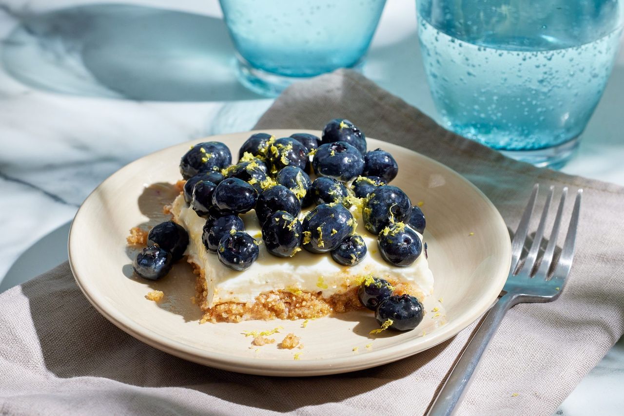 a recipe photo of the Lemon Blueberry Cheesecake Bars Credit: Photographer: Carson Downing, Food stylist: Annie Probst, Prop Stylist: Joseph Wanek