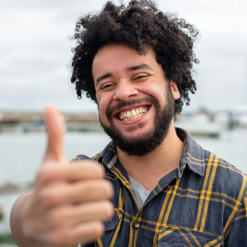 optimistic man doing a thumbs up and looking happy