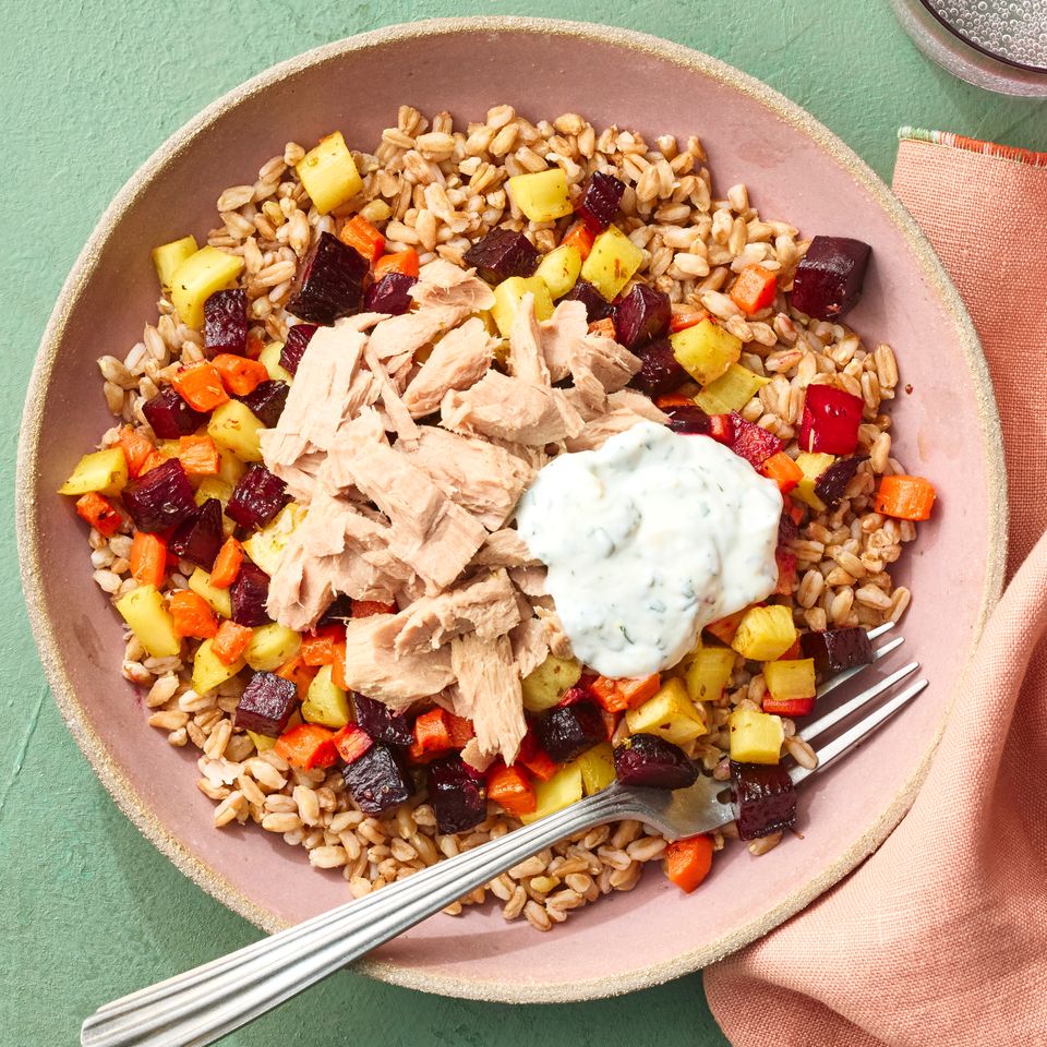A recipe image of Grain Bowl with Canned Tuna, Farro & Veggies. Credit: Photographer: Greg Dupree, Prop Stylist: Claire Spollen, Food Stylist: Chelsea Zimme.