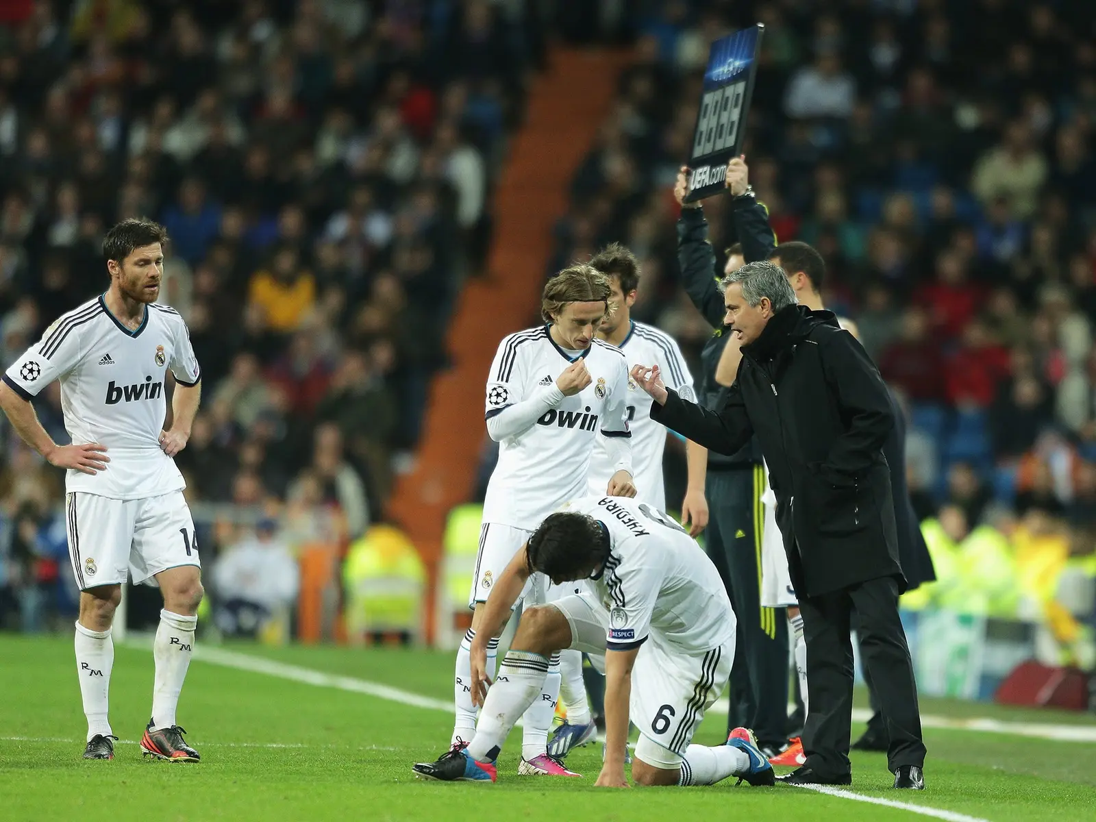 Jose Mourinho gesturing to Real Madrid players during a match at the Santiago Bernabeu stadium.