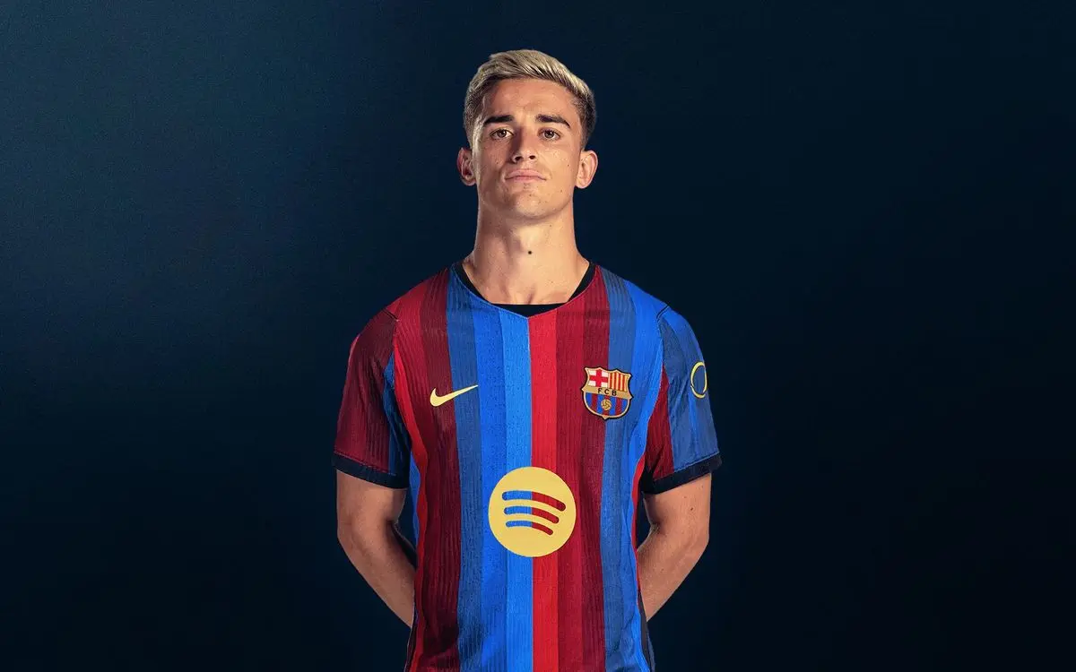 Portrait of Gavi wearing the FC Barcelona home kit against a dark blue background