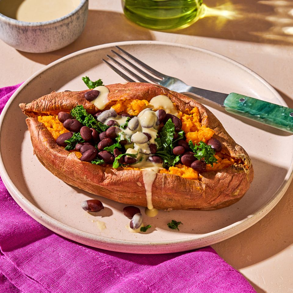 Stuffed Sweet Potato with Hummus Dressing, low angle on a plate Credit: Ali Redmond