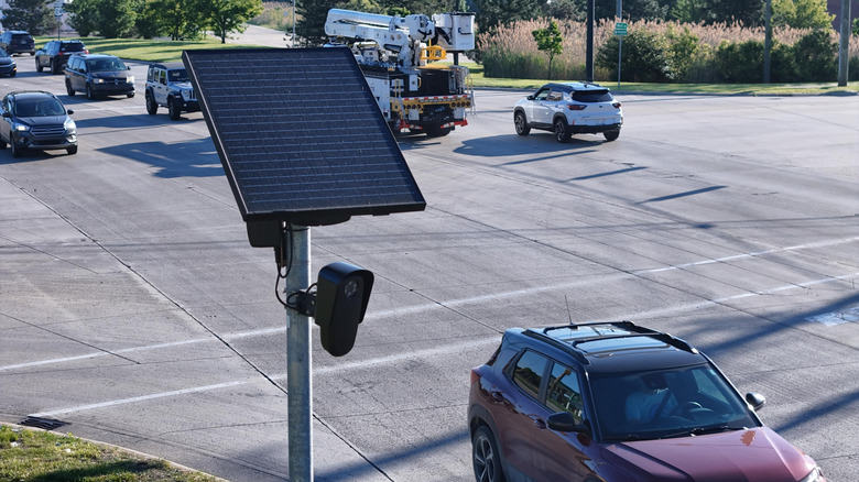 Flock Safety roadside traffic surveillance and data collection camera monitoring vehicles on a public roadway
