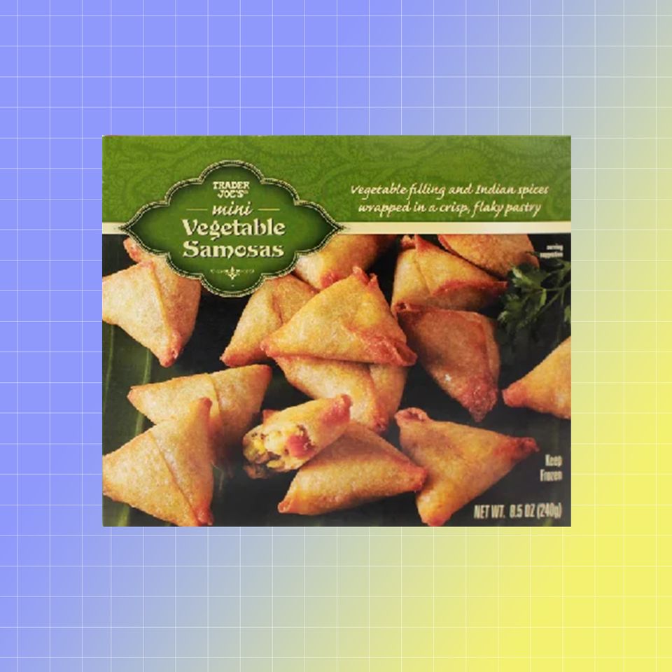 A box of Trader Joes Mini Vegetable Samosas with triangles of the savory pastry on the packaging Credit: Trader Joe's. EatingWell design.