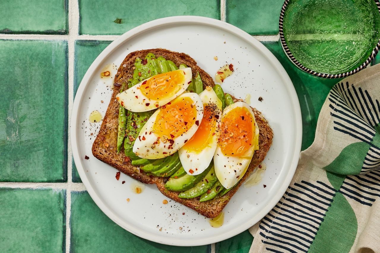 a recipe photo of the Jammy Egg & Avocado Toast Credit: Photographer: Robby Lozano, Food Stylist: Margaret Dickey, Prop Stylist: Julia Bayless