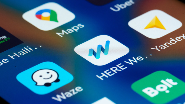 Close-up view of a smartphone screen displaying popular navigation and mobility apps