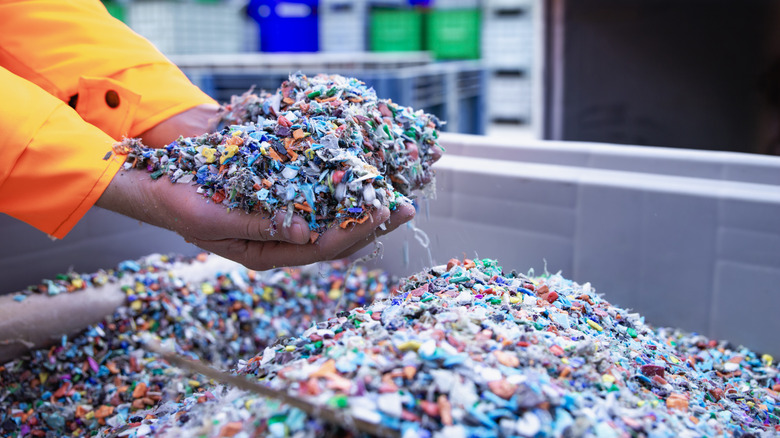 Two hands holding recycled plastic